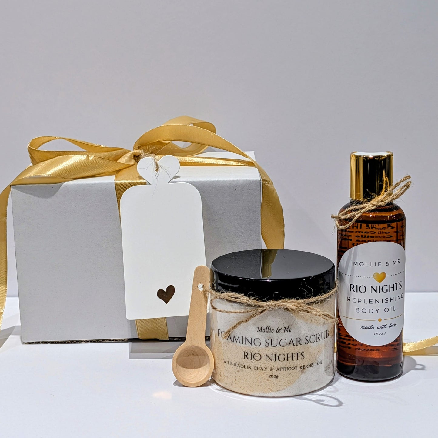 Mollie & Me bath & body set with a jar, bottle, and gift box on a white background