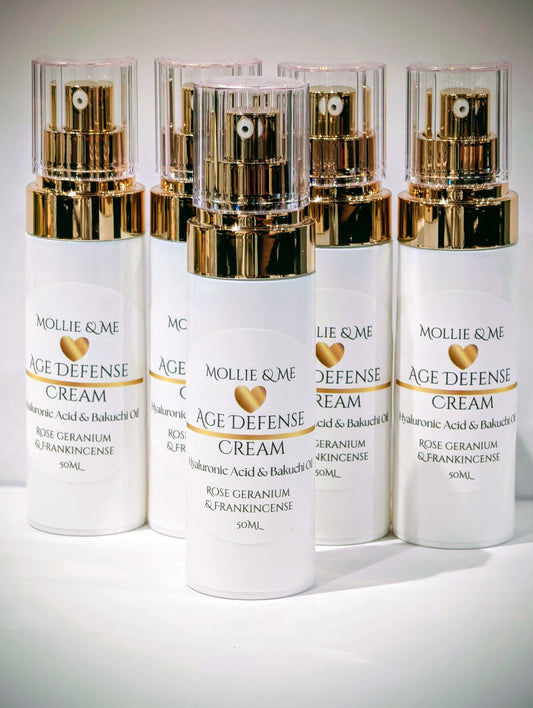Four bottles of Mollie & Me Age Defense Cream on a white background