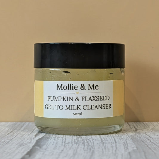 A 60ml glass jar of Mollies & Me's pumpkin & flaxseed Gel to milk organic cleanser with a white and yellow label.A 100% natural, toxic free cleanser for all.skin types but especially good for dry & mature skin.
