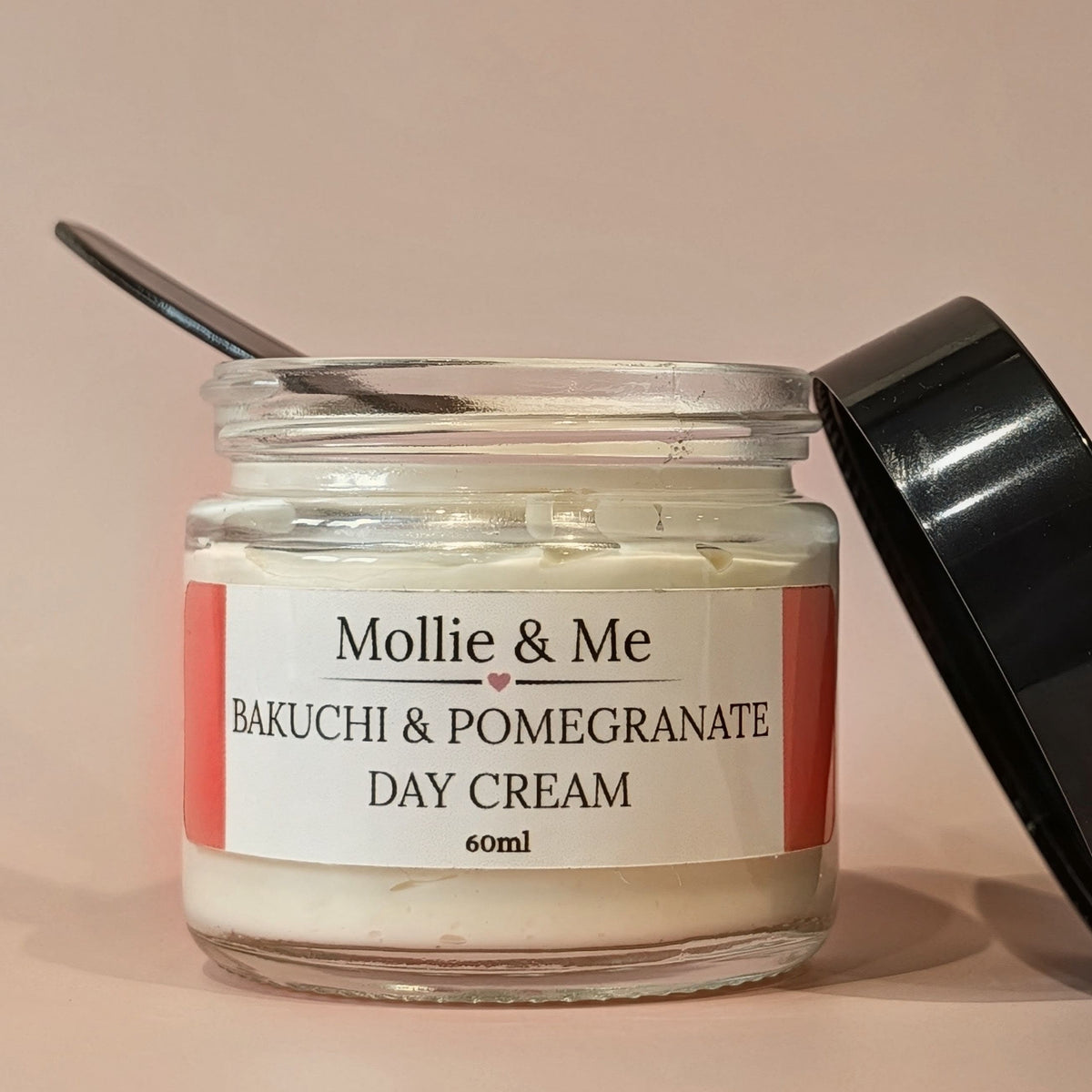 Mollie & Me Bakuchi & pomegranate day cream.A natural face cream that's perfect for menopausal/ pre menopausal skin. 60ml in a glass jar with a black lid. Handmade in small batches in Kent.