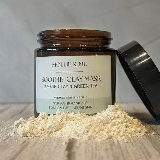 An amber glass of Mollie & Me's soothe, botanical clay mask with Kaolin Clay and green tea powder for sensitive skin.
